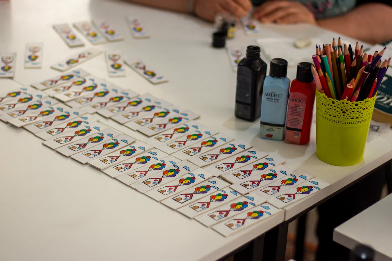 services-07 Vibrant DIY card crafting setup with paint and pencils on display.