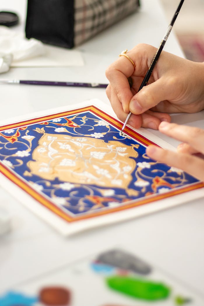 portfolio-06 Detailed artistic process of hand-painting a ceramic tile with traditional patterns.